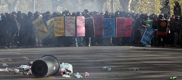 Demonstrators prepare to clash with police during a protest against Italian Government austerity measures in Rome, Wednesday, Nov. 14, 2012. Workers across the European Union sought to present a united front against rampant unemployment and government spending cuts Wednesday with a string of strikes and demonstrations across the region. Protesters clashed with police in various demonstrations in Rome, Milan, Turin, Padua and Brescia. (AP Photo/Gregorio Borgia)
