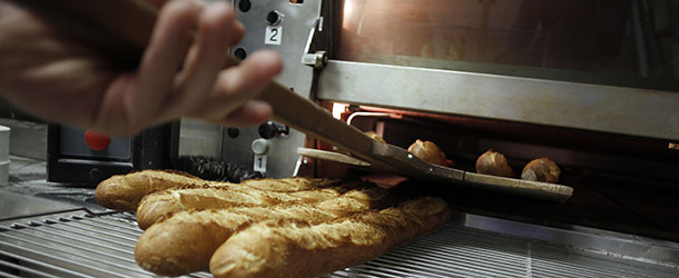 An apprentice removes bread from the oven at the National Bakery and Pastry Institute (INBP &#8211; Institut National de Boulangerie et de Patisserie) on November 20, 2012 in the northwestern city of Rouen. AFP PHOTO/CHARLY TRIBALLEAU (Photo credit should read CHARLY TRIBALLEAU/AFP/Getty Images)
