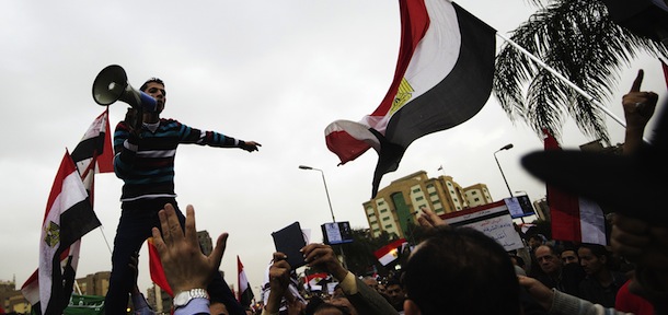 An Egyptian man shouts slogans during a march towards the presidential palace in Cairo on December 4, 2012, protesting President Mohamed Morsi&#8217;s decree widening his powers. Tens of thousands of demonstrators encircled the presidential palace after riot police failed to keep them at bay with tear gas, in a growing crisis over President Morsi. AFP PHOTO/GIANLUIGI GUERCIA (Photo credit should read GIANLUIGI GUERCIA/AFP/Getty Images)
