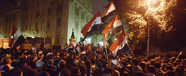 Egyptian protesters demonstrate outside of the presidential palace in Cairo on December 4, 2012, against President Mohamed Morsi&#8217;s decree widening his powers. Tens of thousands of demonstrators encircled the presidential palace after riot police failed to keep them at bay with tear gas, in a growing crisis over President Morsi. AFP PHOTO/GIANLUIGI GUERCIA (Photo credit should read GIANLUIGI GUERCIA/AFP/Getty Images)
