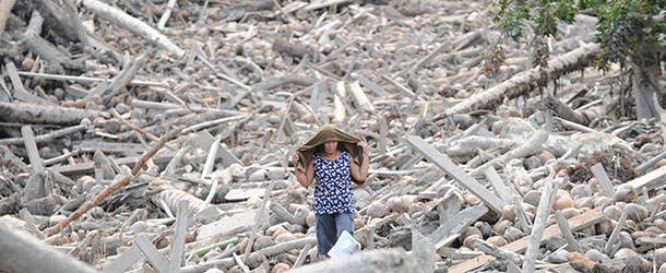 A resident searches for missing relatives amongst the debris, swept away by flash floods at the height Typhoon Bopha in New Bataan, Compostela Valley province on December 7, 2012. President Benigno Aquino vowed action on the Philippines&#8217; typhoon disasters December 7 as bruised and grieving survivors tried to recover from the latest that left nearly 500 people dead. AFP PHOTO/TED ALJIBE (Photo credit should read TED ALJIBE/AFP/Getty Images)
