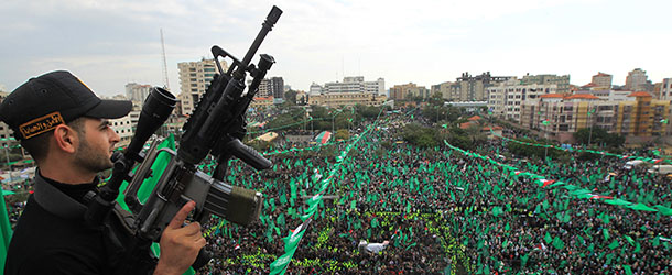 A member of Hamas stands guard during a rally to mark the 25th anniversary of the founding of the Islamist movement, in Gaza on December 8, 2012. Hamas leader in exile Khaled Meshaal made his first visit to Gaza, timed to coincide with the 25th anniversary of the Islamist movement&#8217;s founding. AFP PHOTO/MAHMUD HAMS (Photo credit should read MAHMUD HAMS/AFP/Getty Images)
