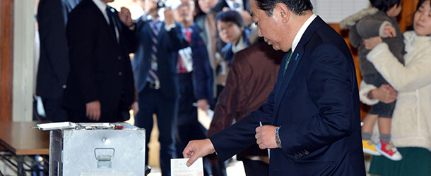 Japanese Prime Minister and leader of the ruling Democratic Party of Japan Yoshihiko Noda casts his vote in general election and at a polling station in Funabashi, suburban Tokyo on December 16, 2012. Voters began casting ballots in Japan for a general election likely to return long-ruling conservatives to power after three years in the wilderness. AFP PHOTO / Tadayuki YOSHIKAWA (Photo credit should read Tadayuki YOSHIKAWA/AFP/Getty Images)
