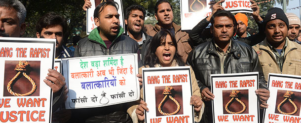 Indian protestors hold placards as they shout slogans during a protest demanding better security for women in New Delhi on December 29, 2012, as Indian leaders appealled for calm fearing fresh outbursts of protests after the death of a gang-rape student victim. New Delhi&#8217;s top police officer and chief minister have urged people to mourn the death of a gang-rape victim in a peaceful manner as large parts of the city-centre were sealed off. The calls for calm came after an Indian woman who was gang-raped on a New Delhi bus died in a Singapore hospital after suffering severe organ failure. AFP PHOTO/RAVEENDRAN (Photo credit should read RAVEENDRAN/AFP/Getty Images)
