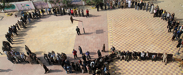 Egyptians wait in line to cast their votes during a referendum on a disputed constitution drafted by Islamist supporters of President Morsi in Cairo, Egypt, Saturday, Dec. 15, 2012. (AP Photo/Ahmed Gomaa)
