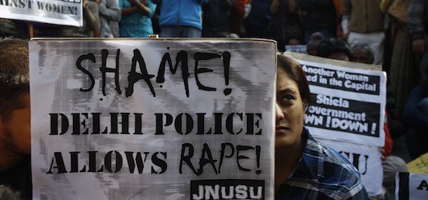 An Indian woman along with the others participates in a protest condemning the gang rape of a 23-year-old student on a city bus late Sunday in New Delhi, India, Tuesday, Dec. 18, 2012. The Indian parliament Tuesday witnessed outrage over the issue even as the victim is battling for her life at a city hospital. (AP Photo/Tsering Topgyal)
