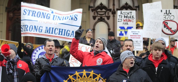 during a rally on the State Capitol grounds in Lansing, Mich., Tuesday, Dec. 11, 2012. The crowd is protesting right-to-work legislation that was passed by the state legislature last week. (AP Photo/Carlos Osorio)
