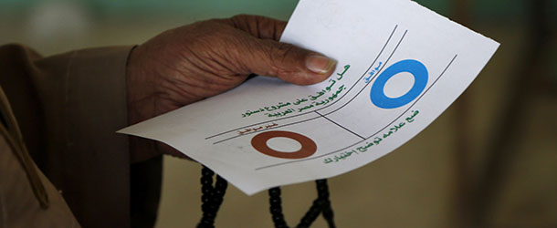 An Egyptian man holds a ballot before casting his vote at a polling station during a referendum on a disputed constitution drafted by Islamist supporters of President Mohammed Morsi in Cairo, Egypt, Saturday, Dec. 15, 2012. Egyptians were voting on Saturday on a proposed constitution that has polarized their nation, with Morsi and his Islamist supporters backing the charter, while liberals, moderate Muslims and Christians oppose it. (AP Photo/Petr David Josek)
