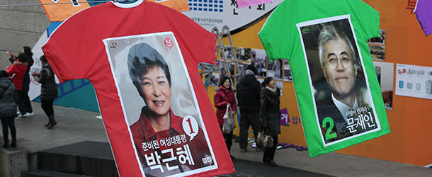 Election posters of presidential candidates Park Geun-hye (1) of the ruling Saenuri Party and Moon Jae-in (2) of the main opposition Democratic United Party, hang down in Seoul&#8217;s Cheonggye Stream, South Korea, Tuesday, Dec. 11, 2012. The display made by the Seoul City&#8217;s election management committee is aimed at encouraging people to vote in the elections on Dec. 19. T-shirts in background read: &#8220;Let&#8217;s vote all of us and Dec. 19 is presidential election day. (AP Photo/Ahn Young-joon)
