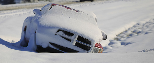 A vehicle abandoned by its driver lays buried in snow along the median of Mauamelle Blvd. in Little Rock, Ark. Wednesday morning, Dec. 26, 2012. A historic Christmas night winter storm dropped upwards of a foot of snow on parts of Arkansas, shutting down workplaces, downing trees and power lines and turning travel treacherous. (AP Photo/The Arkansas Democrat-Gazette, Benjamin Krain) ARKANSAS TIMES OUT; ARKANSAS BUSINESS OUT
