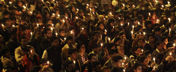 Indians march the streets while holding candles as they mourn the death of a gang rape victim in New Delhi, India, Saturday, Dec. 29, 2012. Indian police charged six men with murder on Saturday, adding to accusations that they beat and gang-raped the woman on a New Delhi bus nearly two weeks ago in a case that shocked the country. The murder charges were laid after the woman died earlier Saturday in a Singapore hospital where she has been flown for treatment. (AP Photo/Altaf Qadri)
