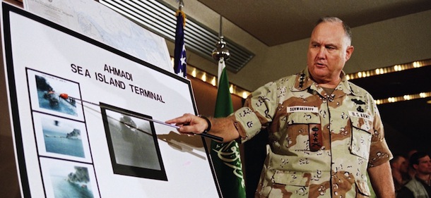 U.S. Army Gen. Norman Schwarzkopf points to row of photos of Kuwait?s Ahmadi Sea Island Terminal on fire after a U.S. attack set the facility on fire. He called the dumping of oil into the Persian Gulf inhumane, at the news briefing in Riyadh on Sunday, Jan. 27, 1991. (AP Photo/Laurent Rebours)
