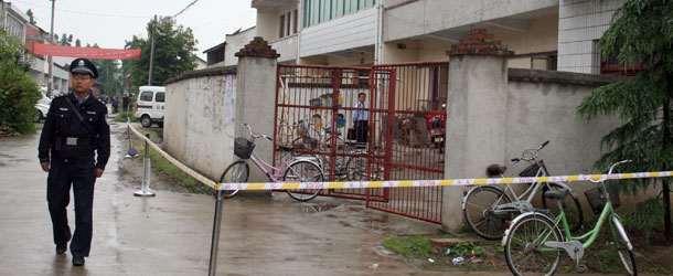 A Chinese policeman walks past the kindergarten where seven children and a teacher were hacked to death with a cleaver in Hanzhong, in northern China&#8217;s Shaanxi province on May 12, 2010, the latest in a series of violent school assaults. The attack, which ended with the assailant&#8217;s suicide, was the fifth on young school children in less than two months, and comes despite a push to boost security in and around schools across the country. CHINA OUT AFP PHOTO (Photo credit should read AFP/AFP/Getty Images)
