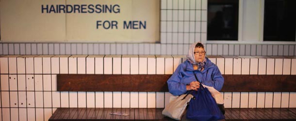 PRESTON, LANCASHIRE &#8211; DECEMBER 17: A traveller waits for their bus connection at Preston Bus Station on December 17, 2012 in Preston, Lancashire. Preston Bus Station is described as great example of Brutalist architecture and is on a list of &#8220;treasured places at risk&#8221; compiled by the World Monument organisation. A 1,500 signature petition has been complied to save the bus station and it&#8217;s public car park which was also recently voted as Preston&#8217;s favourite building and today Preston City Council will vote to decide the future of the bus station which was built in 1969. The council says that it will cost 23 million GBP to refurbish and only 16 million GBP to demolish. (Photo by Christopher Furlong/Getty Images)
