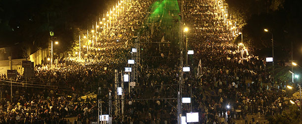 Egyptian protesters gather outside the presidential palace after they broke through a barbed wire barricade that was keeping them from getting closer to the presidential palace, in Cairo, Egypt, Friday, Dec. 7, 2012. Egypt&#8217;s political crisis spiraled deeper into bitterness and recrimination Friday as thousands of Islamist backers of the president vowed vengeance at a funeral for men killed in bloody clashes earlier this week and large crowds of the president&#8217;s opponents marched on his palace to increase pressure after he rejected their demands. (AP Photo/Hassan Ammar)
