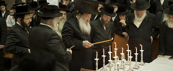 Ultra Orthodox Jewish men light candles on the Jewish holiday of Hanukkah in Bnei Brak, near Tel Aviv, Israel, Monday, Dec. 10, 2012. (AP Photo/Dan Balilty)
