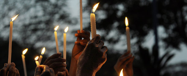 Indian activists take part in a candlelight vigil in Kolkata on December 30, 2012, after the cremation ceremony for a gangrape victim. The victim of a gang-rape and murder which triggered an outpouring of grief and anger across India was cremated at a private ceremony, hours after her body was flown home from Singapore. A student of 23-year-old, the focus of nationwide protests since she was brutally attacked on a bus in New Delhi two weeks ago, was cremated away from the public glare at the request of her traumatised parents. AFP PHOTO/Dibyangshu SARKAR (Photo credit should read DIBYANGSHU SARKAR/AFP/Getty Images)
