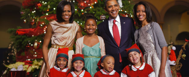 US President Barack Obama, First Lady Michelle Obama with daughters Malia (R) and Sasha (2nd L) pose with children dressed as elves before the taping of the &#8220;Christmas in Washington&#8221; television special on December 9, 2012 at the Building Museum in Washington. AFP PHOTO/Mandel NGAN (Photo credit should read MANDEL NGAN/AFP/Getty Images)
