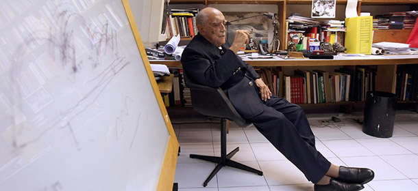 Brazilian world famous architect Oscar Niemeier smokes in his studio after being decorated with the Legion of Honor by France&#8217;s ambassador to Brazil Antoine Pouillieute, 12 December 2007 in Rio de Janeiro, Brazil. Niemeyer will celebrate his 100th anniversary next 15 December. AFP PHOTO/ANTONIO SCORZA (Photo credit should read ANTONIO SCORZA/AFP/Getty Images)
