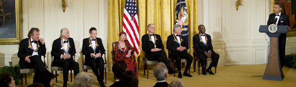 President Barack Obama, right, with the 2012 Kennedy Center Honors recipients, from left, rock band Led Zeppelin singer Robert Plant, guitarist Jimmy Page, and keyboardist/bassist John Paul Jones, ballerina Natalia Makarova, comedian and television host David Letterman, actor and director Dustin Hoffman and bluesman Buddy Guy, speaks during a reception for the honorees in the East Room of the White House in Washington, Sunday, Dec. 2, 2012. (AP Photo/Manuel Balce Ceneta)
