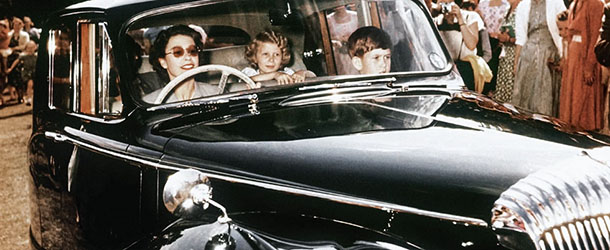 1957, Windsor, Berkshire, England, UK &#8212; Queen Elizabeth II driving her children Prince Charles and Princess Anne at Windsor, watched by a group of onlookers, 1957. &#8212; Image by Â© Hulton-Deutsch Collection/CORBIS
