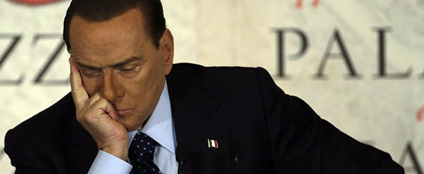 People of Freedom party leader Silvio Berlusconi attends a book presentation of Italian journalist Bruno Vespa &#8220;Il Palazzo e la Piazza&#8221; (The Palace and the Square) in Rome, Wednesday, Dec. 12, 2012. At a public appearance Wednesday night, Berlusconi claimed that he would back a government of moderates in the next election should Monti agree to head it and that in such a case he would step aside as a candidate. (AP Photo/Gregorio Borgia)

