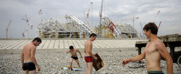 Workers take a break in front of the &#8220;Fisht&#8221; Olympic stadium under construction for the Sochi 2014 Winter Olympics in the Russian Black Sea resort of Sochi on August 6, 2012. Russia&#8217;s government said on August 6 it had been put on notice about bureaucratic wrangling delaying preparations for the opening ceremony of the 2014 Sochi Winter Olympic Games.The Sochi Games are scheduled to take place from February 7, 2014 to February 23, 2014. AFP PHOTO / MIKHAIL MORDASOV (Photo credit should read MIKHAIL MORDASOV/AFP/Getty Images)
