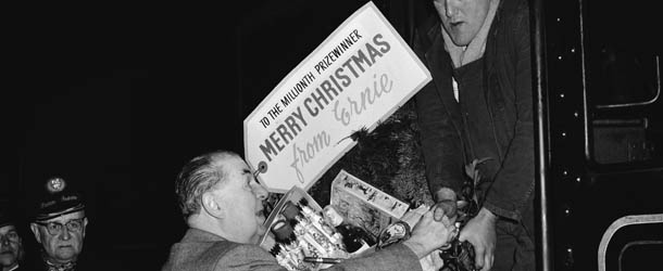 Harold Mackintosh, 1st Viscount Mackintosh of Halifax (1891?1964, left) presents British Rail fireman Frank Whitehouse with a Christmas hamper at Fenchurch Street railway station, London, 20th December 1960. Mackintosh is Chairman of the National Savings Committee and Whitehouse is the millionth winner of the Premium Bond prize draw. The label reads: &#8216; To the millionth prizewinner. Merry Christmas from Ernie&#8217;. Ernie is the computer used to generate the winning numbers in the draw. The name is an acronym for Electronic Random Number Indicator Equipment. (Photo by Keystone/Hulton Archive/Getty Images)
