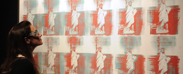 RESTRICTED TO EDITORIAL USE, MANDATORY MENTION OF THE ARTIST UPON PUBLICATION, TO ILLUSTRATE THE EVENT AS SPECIFIED IN THE CAPTION
A woman looks at a painting "Statue of Liberty" by artist Andy Warhol, as it is presented by US auction house Christie's as part of the sale "Post-war and Contemporary evening sale" on October 17, 2012 in Paris. The auction will take place in New York on November 14, 2012. AFP PHOTO / BERTRAND GUAY (Photo credit should read BERTRAND GUAY/AFP/Getty Images)