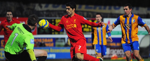 Liverpool's Uruguayan forward Luis Suarez (C) appears to handle the ball in the lead up to his goal during the FA Cup third round football match between Mansfield Town and Liverpool at Field Mill in Mansfield, central England, on January 6, 2013. Liverpool won the match 2-1. AFP PHOTO/ANDREW YATES

RESTRICTED TO EDITORIAL USE. No use with unauthorized audio, video, data, fixture lists, club/league logos or ?live? services. Online in-match use limited to 45 images, no video emulation. No use in betting, games or single club/league/player publications. (Photo credit should read ANDREW YATES/AFP/Getty Images)
