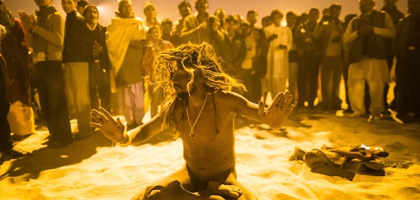 ALLAHABAD, INDIA - JANUARY 15: A naga sadhu performs during an aarti ceremony on the banks of the Ganges river, during the Maha Kumbh Mela on January 15, 2013 in Allahabad, India. The Maha Kumbh Mela, believed to be the largest religious gathering on earth is held every 12 years on the banks of Sangam, the confluence of the holy rivers Ganga, Yamuna and the mythical Saraswati. The Kumbh Mela alternates between the cities of Nasik, Allahabad, Ujjain and Haridwar every three years. The Maha Kumbh Mela celebrated at the holy site of Sangam in Allahabad, is the largest and holiest, celebrated over 55 days, it is expected to attract over 100 million people. (Photo by Daniel Berehulak/Getty Images)