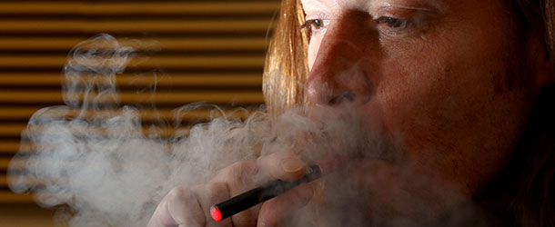 Teri West poses for a photo while using an e-cigarette on Thursday Oct. 27, 2011 in Twin Falls, Idaho. This isn't a futuristic prop from the set of âThe Jetsons.â It's an electronic cigarette and it's been on the market for several years. But the e-smokes are just now catching the eyes of community and health leaders. Across the country, health warnings and bans are being raised regarding the devices, even though little is known about how often they're used or who is using them. AP Photo/Times-News, Ashley Smith)