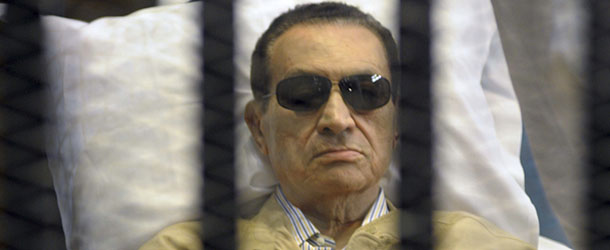 FILE - In this Saturday, June 2, 2012 file photo, Egypt's ex-President Hosni Mubarak lays on a gurney inside a barred cage in the police academy courthouse in Cairo, Egypt. Egypt's official news agency says the prosecutor general has ordered that ex-President Hosni Mubarak be moved from a lush military hospital back to prison, now that his health has improved. (AP Photo, File)