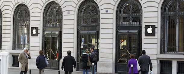 Parisians and tourists wander in front of the Apple store located near the Paris Opera, Tuesday, Jan. 1, 2013. A robbery took place at the flagship store on Monday, a few hours after the close of business. (AP Photo/Remy de la Mauviniere)
