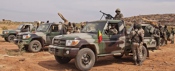 In this Nov. 24, 2012 photo, soldiers from a Malian army special unit stand atop pick-ups mounted with machine guns, following a training exercise in the Barbe military zone, in Mopti, Mali. Secretary-General Ban Ki-moon said Friday, Jan. 11, 2013, that France, Senegal and Nigeria have responded to an appeal from Mali's President Dioncounda Traore for help to counter an offensive by al-Qaida-linked militants who control the northern half of the country and are heading south. The U.N. chief said that assisting the Malian defense forces push back against the Islamist armed groups is "very important."(AP Photo/Francois Rihouay)
