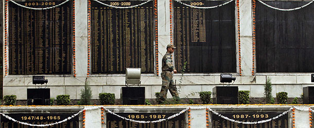 An Indian army soldier walks near the names of his fallen colleagues on the wall at a war memorial during the Kargil Vijay Diwas, or Kargil Victory Day, in Srinagar, India, Thursday, July 26, 2012. Thursday marks the second day of the two-day celebrations of the 13th anniversary of its victory in the Kargil conflict, the 1999 conflict with Pakistan that raged for three months across the disputed Kashmir region had nearly brought the nuclear neighbors to a war. (AP Photo/Mukhtar Khan)