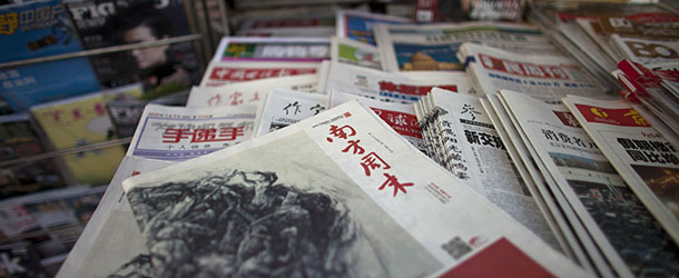 A New Year edition of Southern Weekly, center, published on Thursday Jan. 3, 2013, is exhibited at a newsstand in Beijing, China, Friday, Jan. 4, 2013. In a rare move, a group of Chinese journalists at the Guangdong newspaper known for its edgy reporting are openly confronting state censors after the paper was forced to turn a sharp editorial calling for constitutional rule into a tribute praising the Communist Party in its reputed New Yearâs Message.(AP Photo/Alexander F. Yuan)