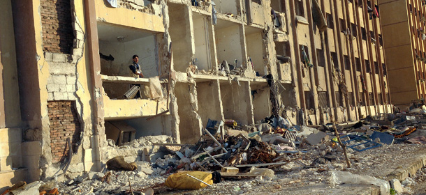 A Syrian man stands in the debris following an explosion outside Aleppo University, between the university dormitories and the architecture faculty, on January 15, 2013. Fifteen people were killed and dozens of others injured in a blast that rocked Aleppo University, the top academic institution in northern Syria's embattled city, said a monitoring group. AFP PHOTO/STR (Photo credit should read -/AFP/Getty Images)