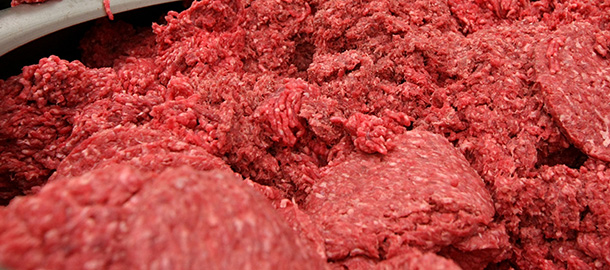 SAN FRANCISCO - JUNE 24: Carlos Vasquez monitors ground beef as it passes through a machine that makes hamburger patties at a meat packing and distribution facility June 24, 2008 in San Francisco, California. Livestock owners are experiencing a sharp increase in the price of corn-based animal feed as corn and soybean prices skyrocket due to an estimated 2 million acres of crop damage from the recent midwest flooding and the continually rising fuel costs. Due to the increase in feed costs, consumers which will get hit in the wallet as prices of meat, dairy and eggs are expected to increase sharply. (Photo by Justin Sullivan/Getty Images)