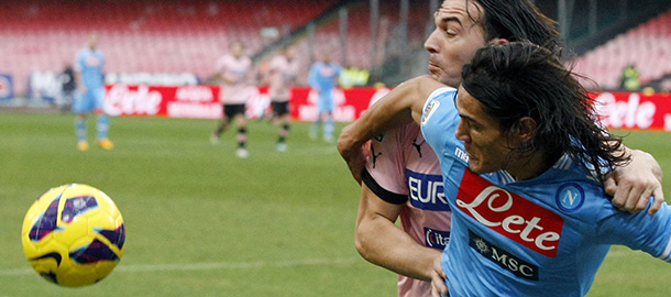Napoli's Uruguayan forward Edinson Cavani (R) vies with Palermo's defender Salvatore Aronica during an Italian Serie A football match between SSC Napoli and USC Palermo in San Paolo Stadium on January 13, 2013. AFP PHOTO / CARLO HERMANN (Photo credit should read CARLO HERMANN/AFP/Getty Images)