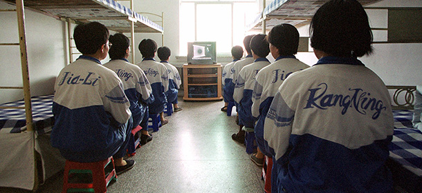 Falun Gong practitioners watch a video about a solar eclipse, part of deprogamming efforts enforced at the Masanjia Reeducation-through-labor camp in northeast China's Liaoning province Tuesday May 22, 2001. The section of the camp for female Falun Gong practitioners holds 483 people and has been nominated as a model correctional facility because of its success in "transforming" practitioners and breaking their allegiance to the spiritual movement that China banned in July 1999. (APPhoto/John Leicester)