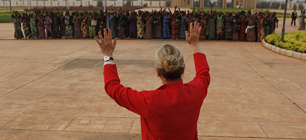 U.S. Secretary of State Hillary Clinton waves to local men and women after her meeting with Togo President Faure Gnassingbe at the Presidential Palace in Lome, Togo, Tuesday Jan. 17, 2012. U.S. Secretary of State Hillary Rodham Clinton this week is taking stock of democratic advances in West Africa after an intense year of diplomacy preoccupied by the Arab Spring. The region's improvements in multiparty governance and the rule of law have come in fits and starts, and often on the back of political violence. (AP Photo/Larry Downing, Pool)