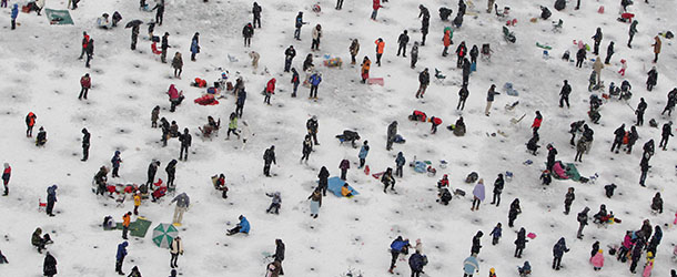 HWACHEON-GUN, SOUTH KOREA - JANUARY 05: Anglers cast lines through holes into a frozen river during an ice fishing competition at the Hwacheon Sancheoneo Ice Festival on January 5, 2013 in Hwacheon-gun, South Korea. The annual event attracts thousands of visitors and features a mountain trout ice fishing competition in which participants compete with tradition lures or with bare hands. (Photo by Chung Sung-Jun/Getty Images)