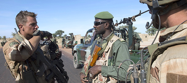 This handout picture taken on January 19, 2013 and released on January 22, 2013 by the French Army Communications Audiovisual office (ECPAD) shows a French soldier (L) speaking with a Malian soldier in Niono. French and Malian troops have recaptured the Malian towns of Diabaly and Douentza from Islamist fighters, France's defence minister said today. Mali's army chief said on January 22 his French-backed forces could reclaim the northern towns of Gao and fabled Timbuktu from Islamists in a month, as the United States began airlifting French troops to Mali. AFP PHOTO / ECPAD / ARNAUD ROINE
RESTRICTED TO EDITORIAL USE - MANDATORY CREDIT "AFP PHOTO / ECPAD / ARNAUD ROINE" - NO MARKETING NO ADVERTISING CAMPAIGNS NO ARCHIVES - DISTRIBUTED AS A SERVICE TO CLIENTS - TO BE USED WITHIN 30 DAYS FROM 01/22/2013 (Photo credit should read ARNAUD ROINE/AFP/Getty Images)