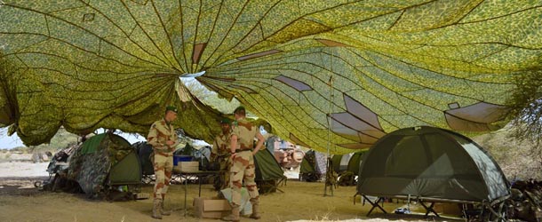 French Foreign Legion troops work under a deployed parachute on January 30, 2013 at Timbuktu airport two days after freeing the northern Malian desert city. French troops on January 30 entered Kidal, the last Islamist bastion in Mali's north after a whirlwind Paris-led offensive, as France urged peace talks to douse ethnic tensions targeting Arabs and Tuaregs. AFP PHOTO / ERIC FEFERBERG (Photo credit should read ERIC FEFERBERG/AFP/Getty Images)