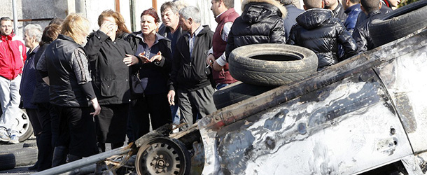 Local people of Rosarno stand behind barricades early on January 9, 2010 after clashes with immigrants workers took place overninght in the southern Italian town. Authorities and reports said that residents beat with iron bars, shot at and ran over immigrants, wounding nine -- two seriously -- in a second night of racially charged violence. AFP PHOTO / Carlo Hermann (Photo credit should read CARLO HERMANN/AFP/Getty Images)