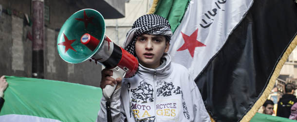 A child uses a megaphone to lead others in chanting Free Syrian Army slogans during a demonstration in the neighborhood of Bustan Al-Qasr, Aleppo, Syria, Friday, Jan. 4, 2013. The U.N. said Wednesday that more than 60,000 people have been killed since Syria's crisis began in March 2011 Ã³ a figure much higher than previous opposition estimates. (AP Photo/ Andoni Lubaki)