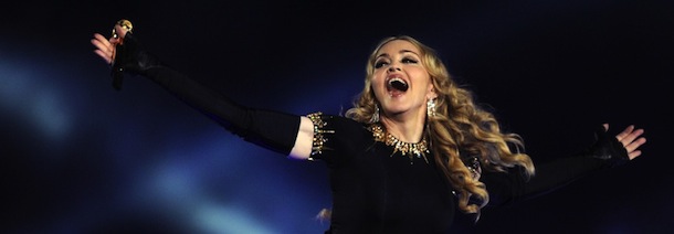 Singer Madonna (R) performs with Redfoo and Sky Blu (L) of LMFAO during the NFL Super Bowl XLVI game halftime show on February 5, 2012 at Lucas Oil Stadium in Indianapolis, Indiana. AFP PHOTO / TIMOTHY A. CLARY The Giants defeated the Patriots 21-17. AFP PHOTO / TIMOTHY A. CLARY (Photo credit should read TIMOTHY A. CLARY/AFP/Getty Images)