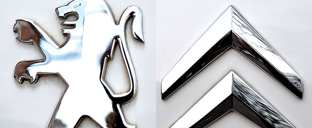 This combination of AFP pictures made in Paris on July 24 ,2012 shows pictures of logo of French carmarkers Peugeot and Citroen. AFP PHOTO / PHILIPPE HUGUEN (Photo credit should read PHILIPPE HUGUEN/AFP/GettyImages)