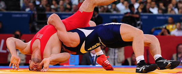 LONDON, ENGLAND - AUGUST 07: Cenk Ildem of Turkey (red) competes with Artur Aleksanyan of Armenia in the Men's Greco-Roman 96 kg Wrestling on Day 11 of the London 2012 Olympic Games at ExCeL on August 7, 2012 in London, England. (Photo by Mike Hewitt/Getty Images)